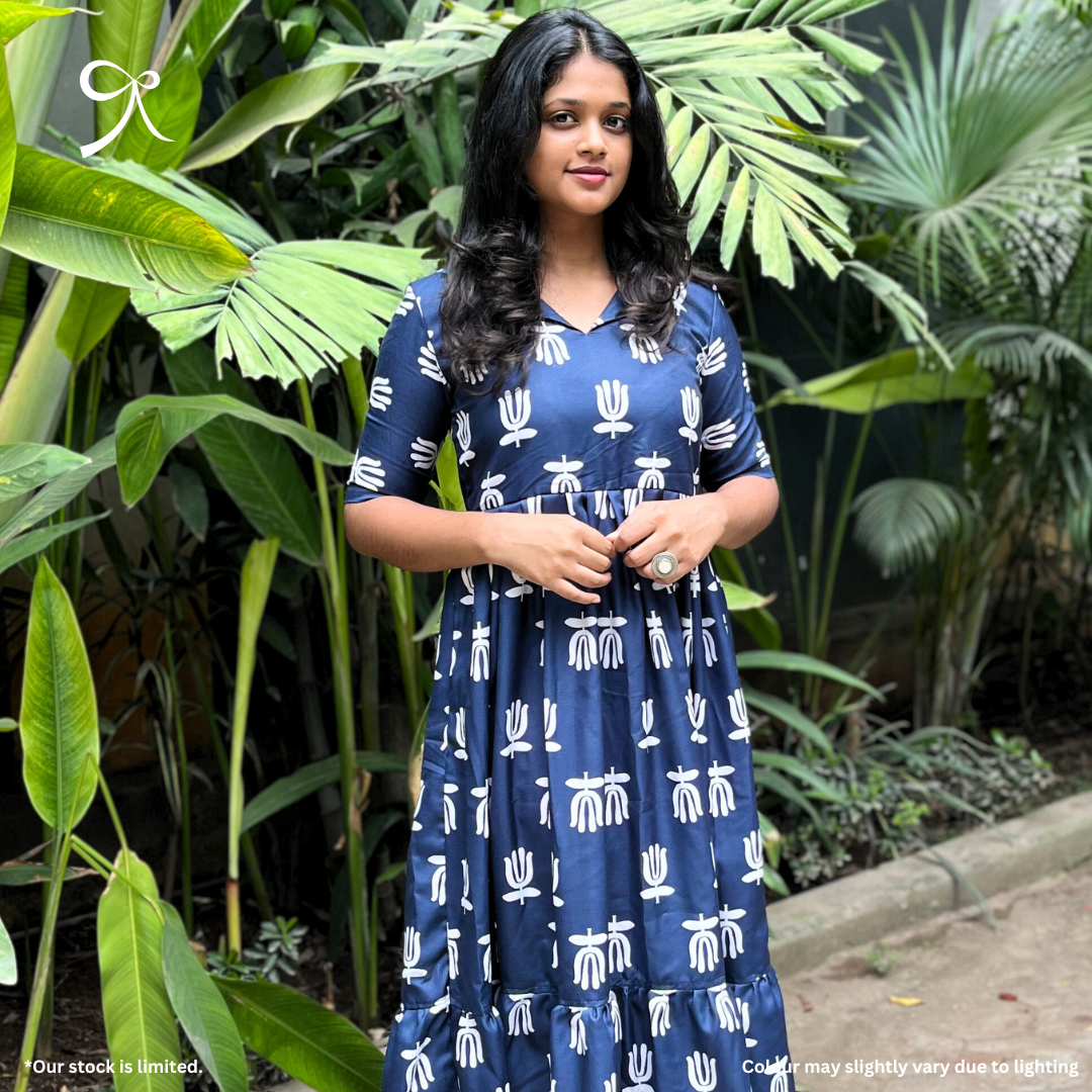 Model wearing Devrobes Navy Linen Handblock Maxi Dress with white handblock motifs and tiered silhouette – breathable and elegant outfit. Page maintained by Creations by Nash.